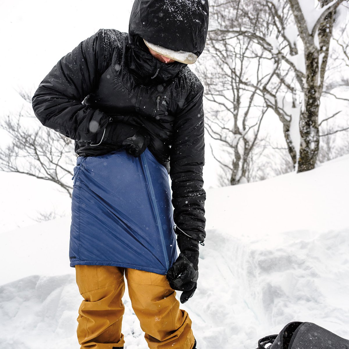Skiers pop a heely in deep snow. 