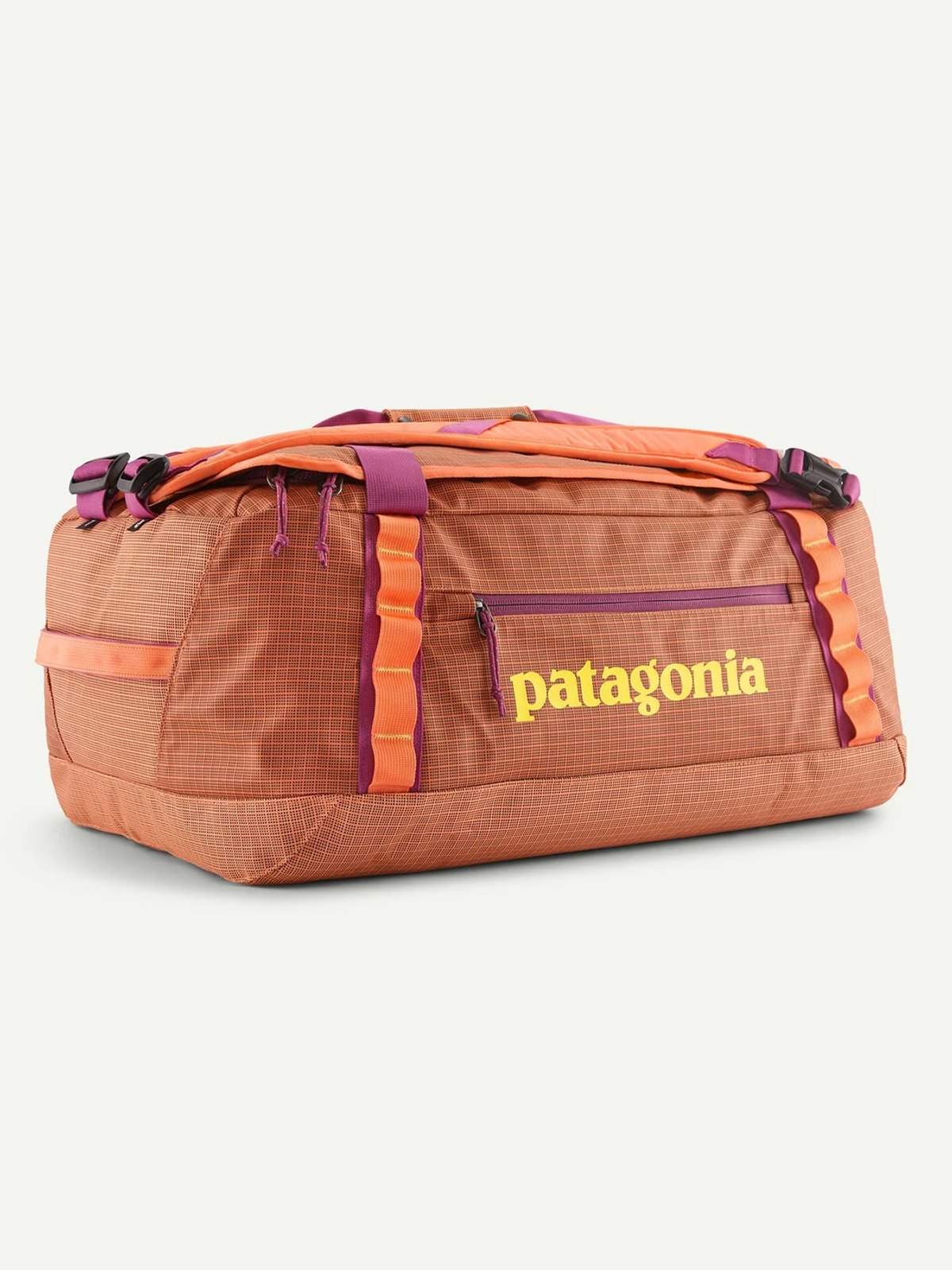 A closeup of an orange Patagonia Black Hole duffel, showcasing the recycled TPU-film laminate that is weather resistant.