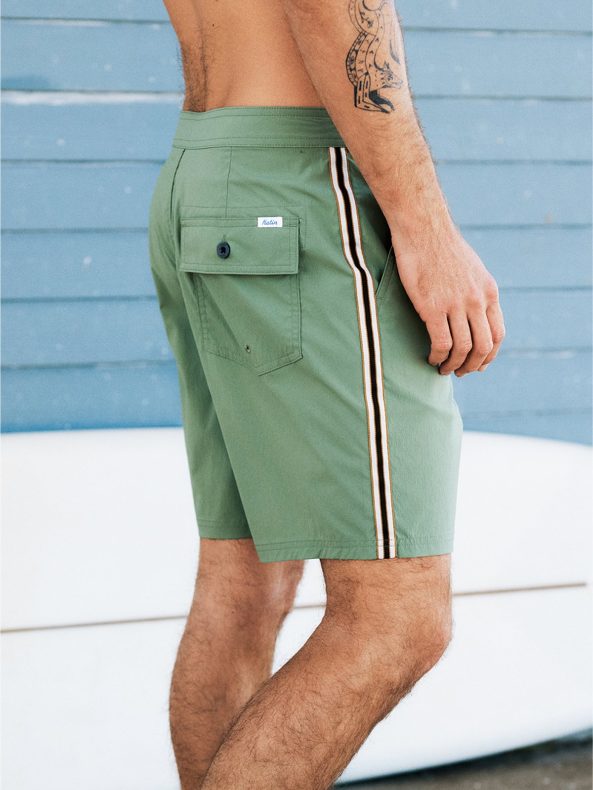 A man wearing green shorts poses.