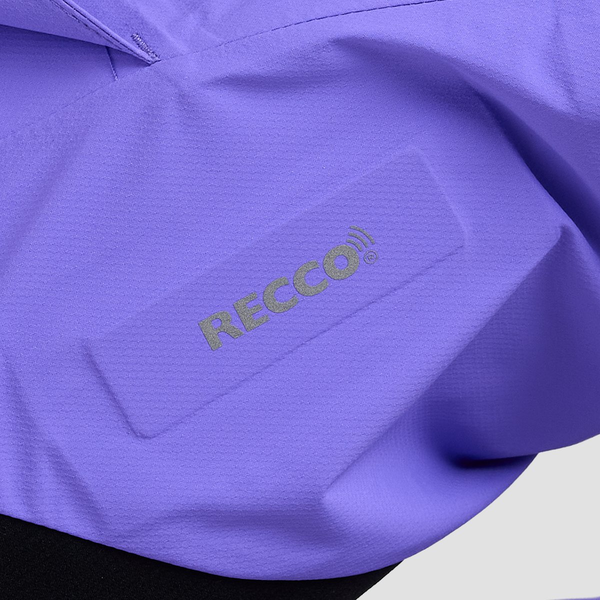 Recco locator integrated into bib pant fabric.