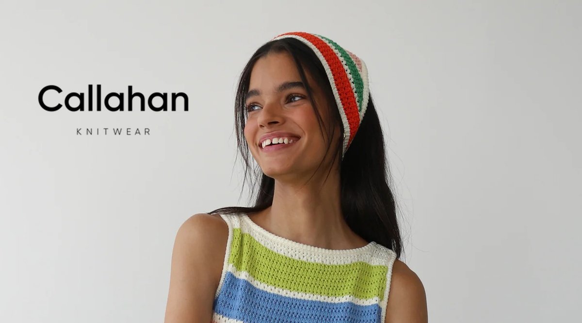 Young woman smiling while wearing a colorful striped bandana and crochetedtop from Callahan Knitwear against a white background.