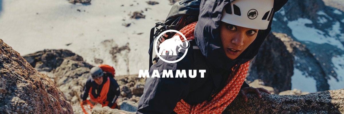 Two people in Mammut climbing gear ascend a snowy, rocky mountain, with the Mammut logo centered over the image.