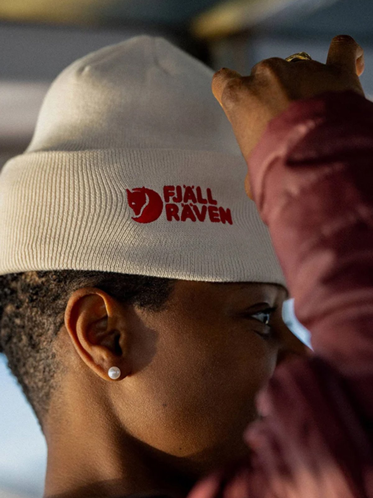 A woman wears a Fjallraven beanie.