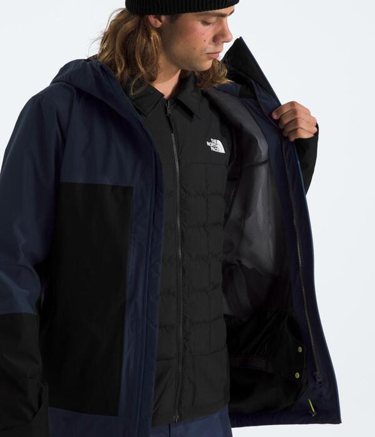 Person opening jacket showing internal lining.