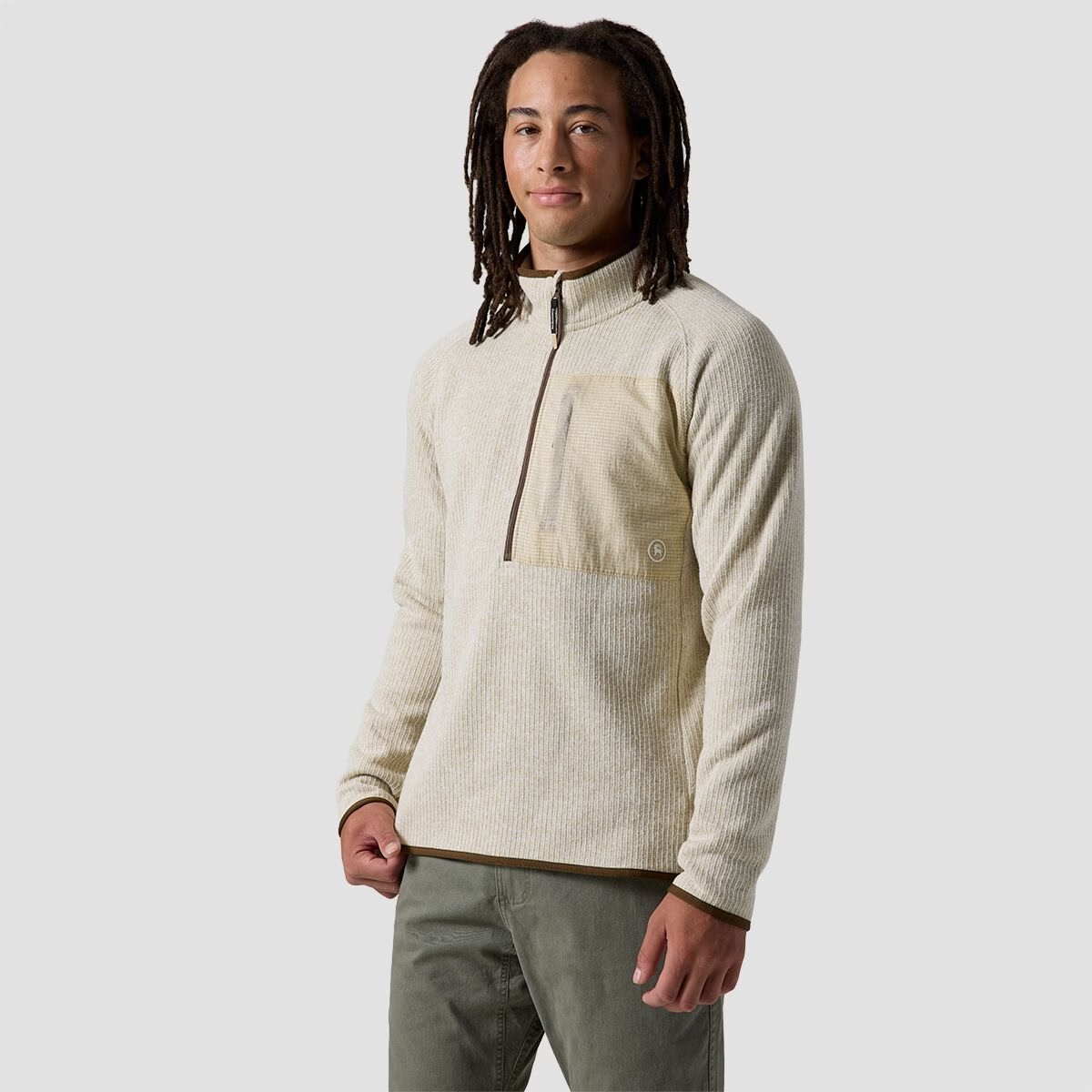 A man wears the BGA Wander Sweater Fleece 1/2 zip.