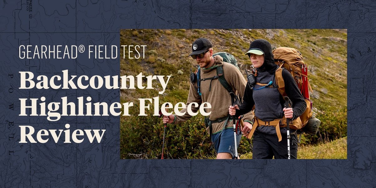 A man and a woman hike outdoors with large backpacks and trekking poles, walking through grassy terrain beneath a cloudy sky. Overlay text reads: "GEARHEAD® FIELD TEST Backcountry Highliner Fleece Review."