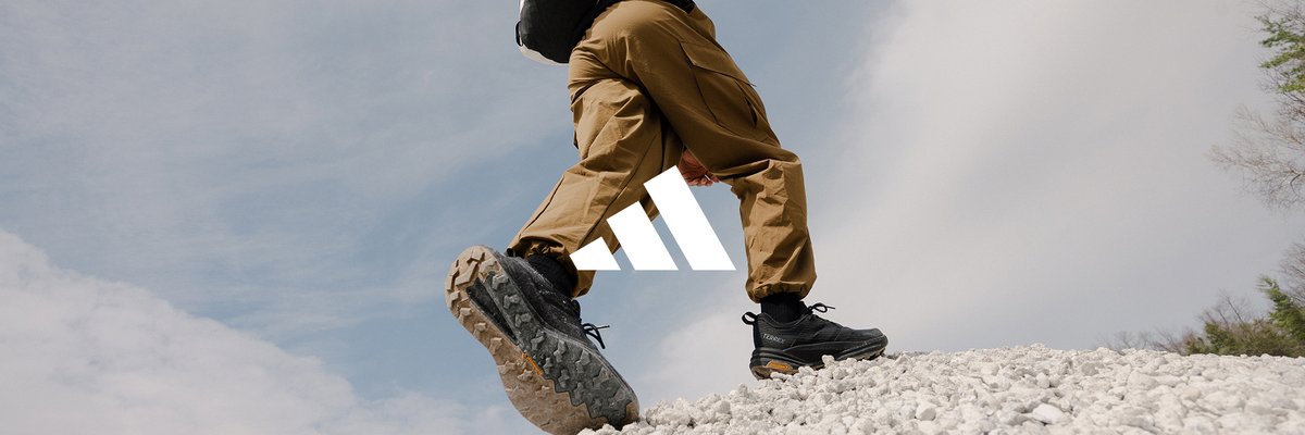 An Adidas Terrex logo is laid over an image of a someone walking