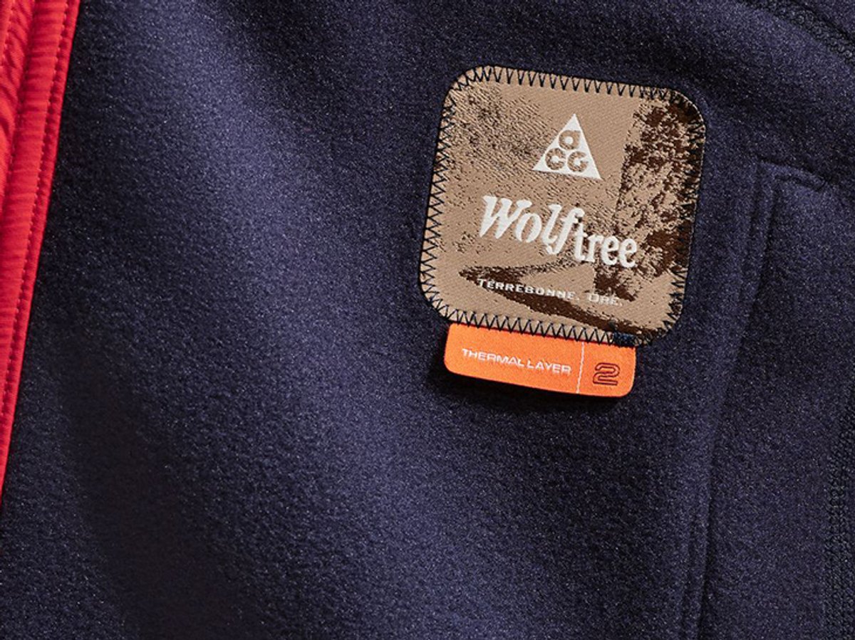 Flece fabric close up showing ACG Wolftree colection patch and Thermal Layer 2 tag.