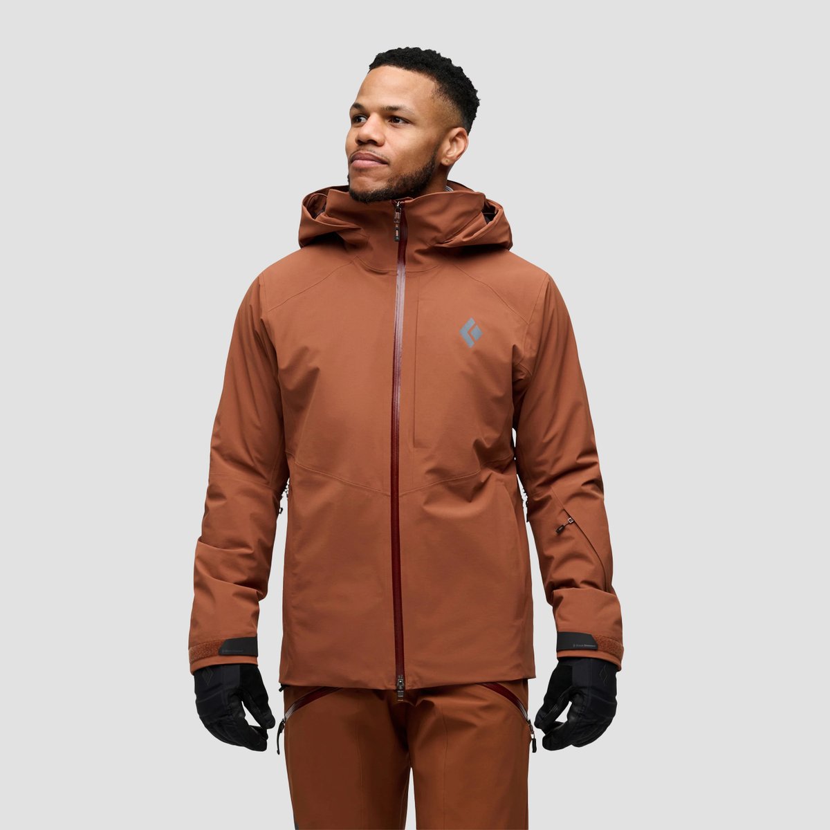 A man looks to the side, wearing the Black Diamond Recon Insulated jacket.