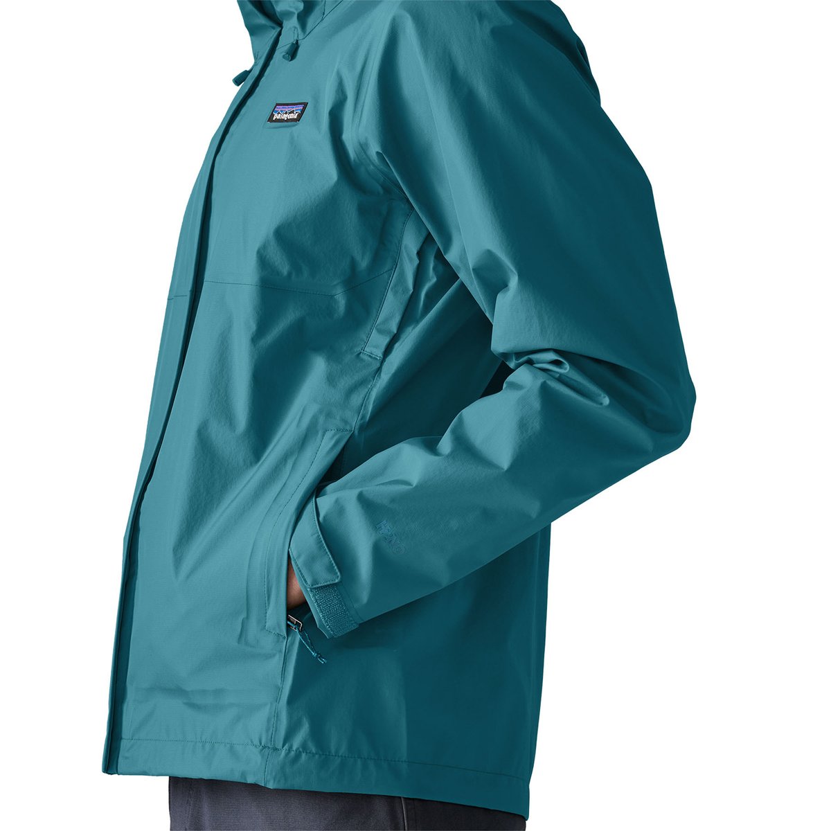 A man places his hands into the handwarmer pockets of the Torrentshell 3L Jacket