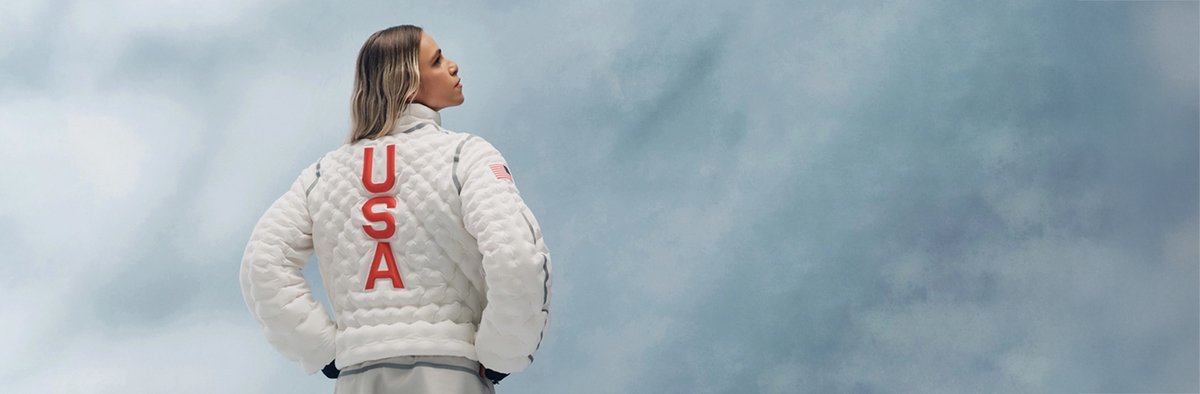 Image showing person wearing white jacket with USA written on int next to Team USA jacket patch.