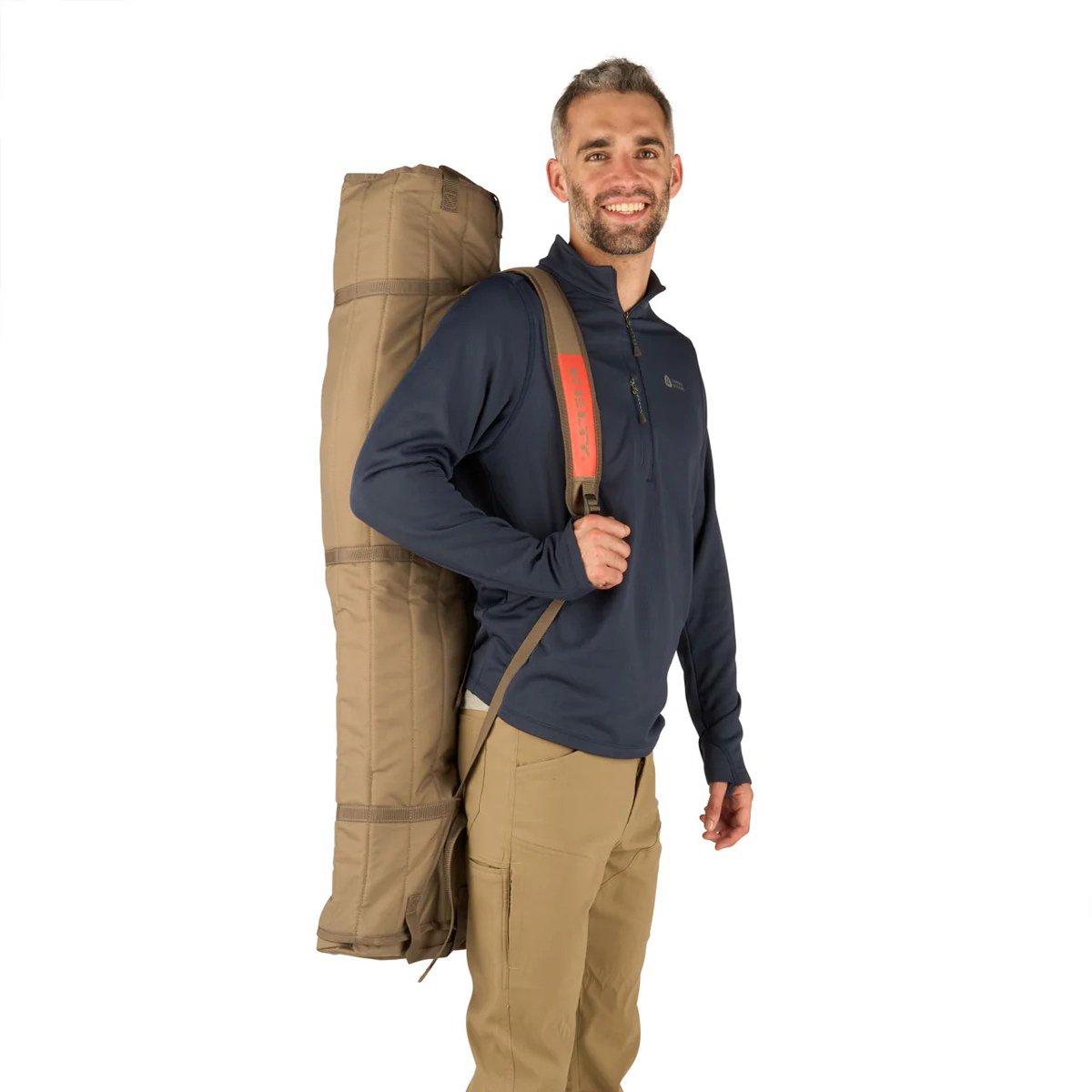 A man carries the Kelty Loveseat over his shoulder, thanks to the carry wrap and its strap.