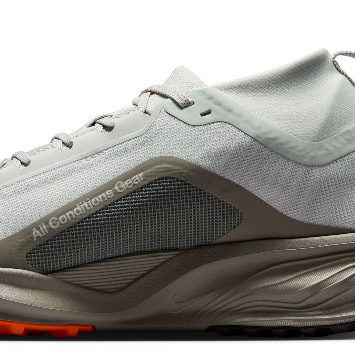 Side profile of the Nike ACG Pegasus Trail GTX heel and khaki midsole, printed with "All Conditions Gear."