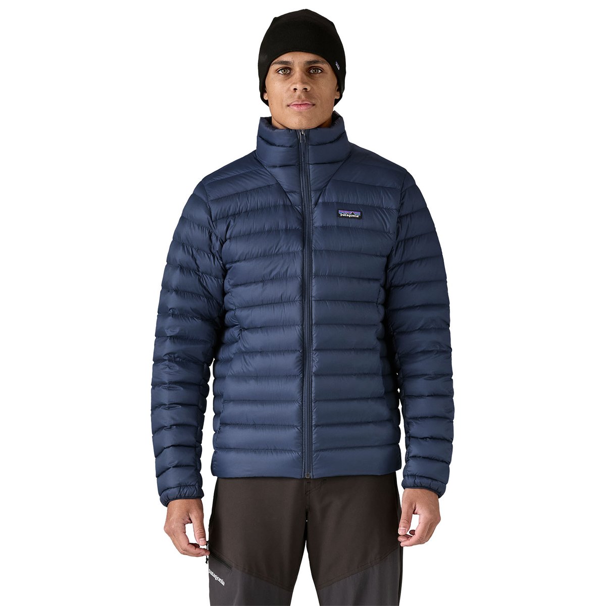A mid-body view of a man wearing the Patagonia Down Sweater Jacket. 