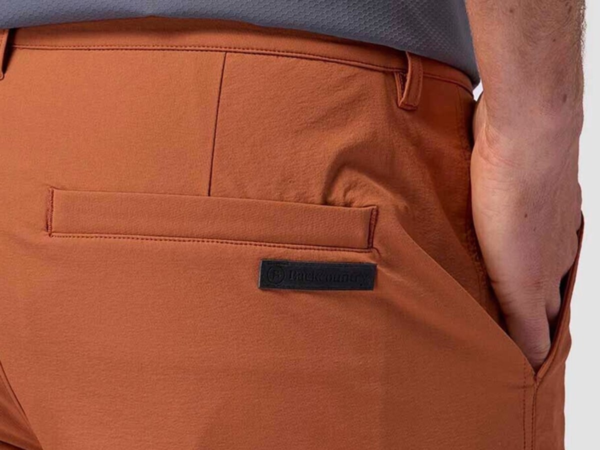 Close-up of shorts fabric showing smooth material and small logo patch.