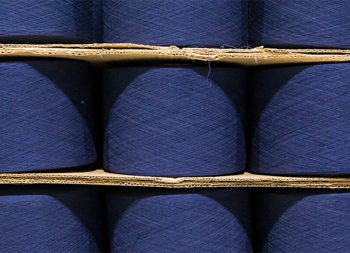 A close up of blue cones of recycled thread