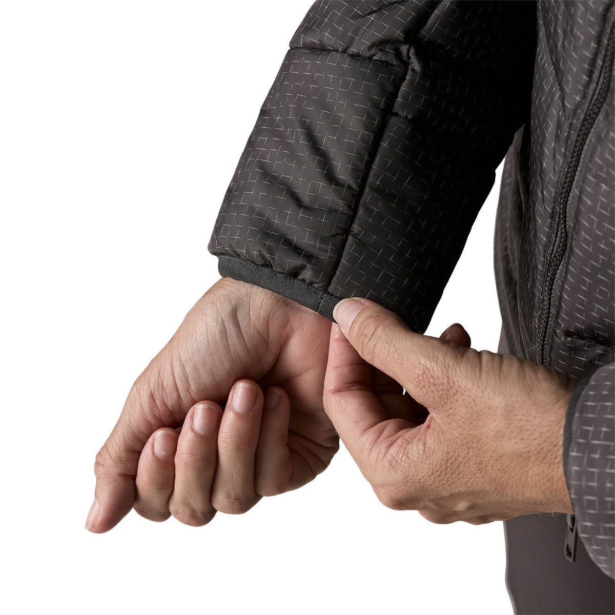Person pulling on elasticated sleeve cuff.