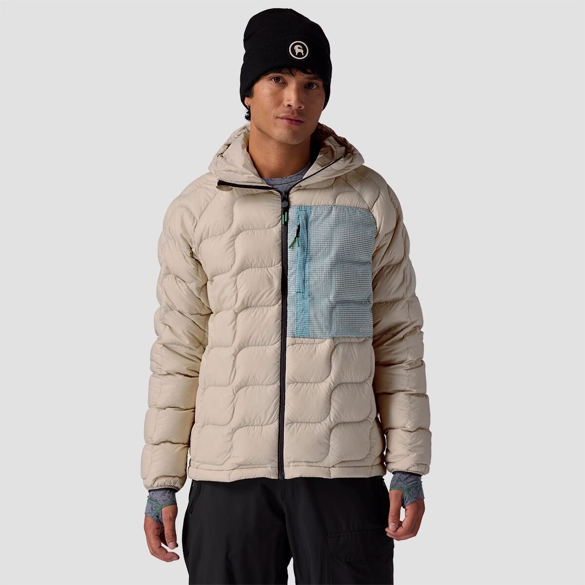 A man wears the BGA Waas ALLIED Down hooded jacket. 