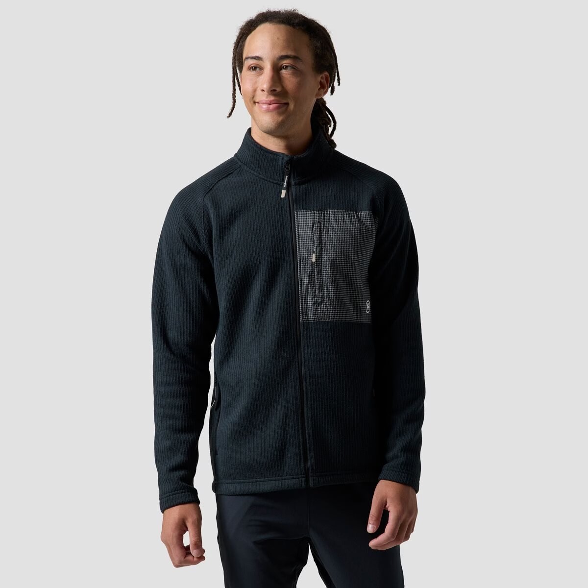 A man wears the BGA Wander Sweater Fleece Jacket.