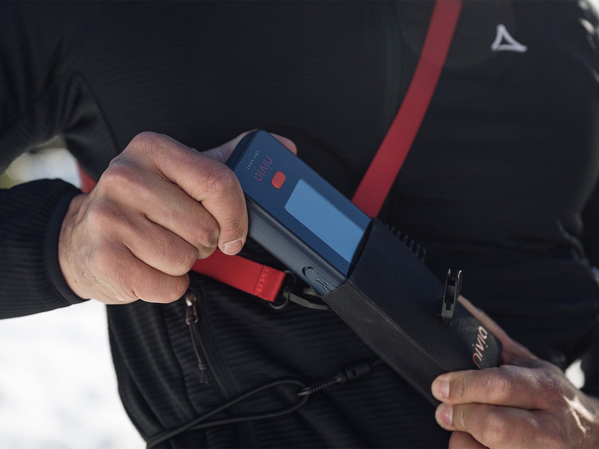 Skier sliding a Nivia 3D Finder into its chest harness.
