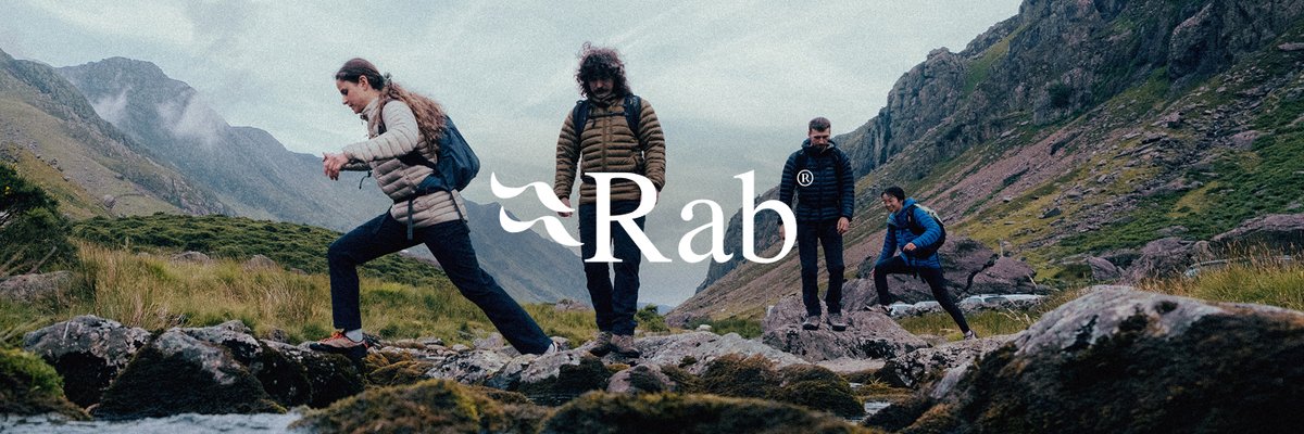 Four people climb over rocky terrain