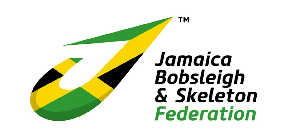 Jamaican bobsleigh team member on bobsleigh track with bobsleigh in the background.