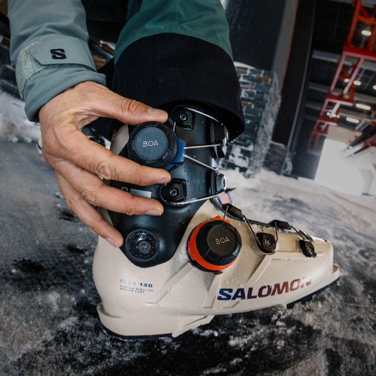 A skier tightens their boots.