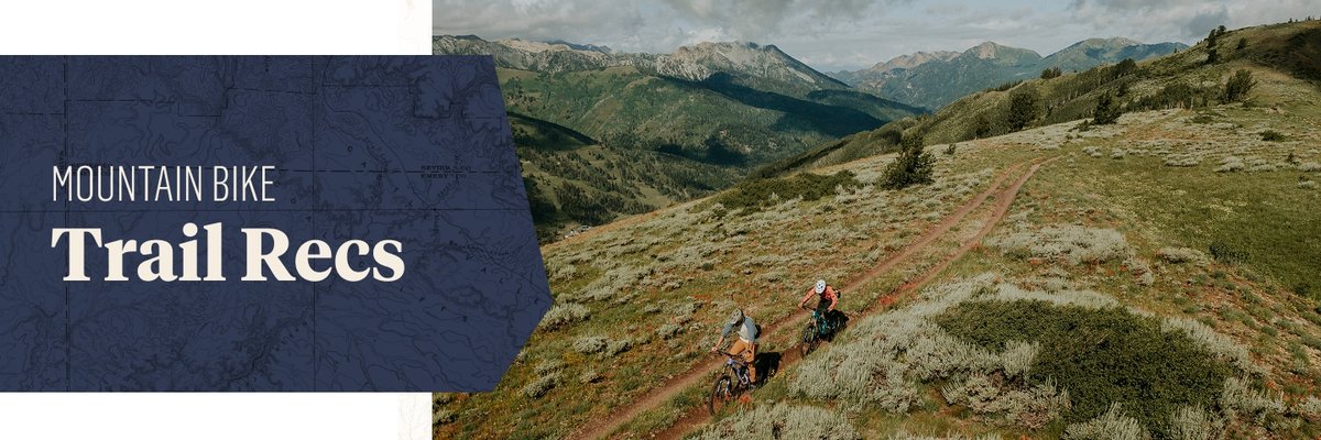 Two people ride down a grassy hill. The words, “Mountain Bike Trail Recs” appear next to them.