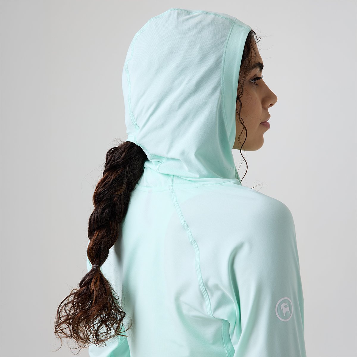 Person wearing Backcountry Tahoe Pro LT sun hood using ponytail slot for their hair. 