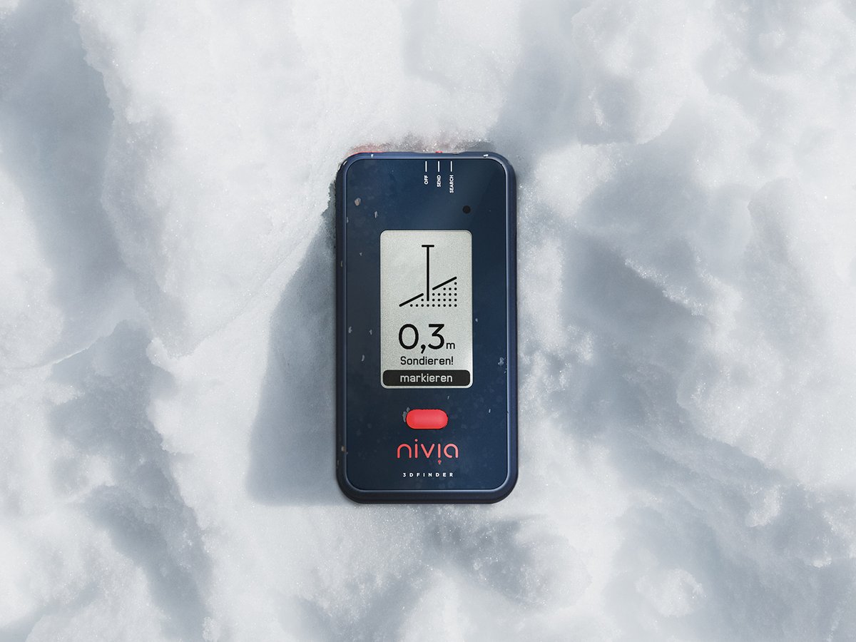 Nivia 3D Finder lying on snow showing a burial depth reading.