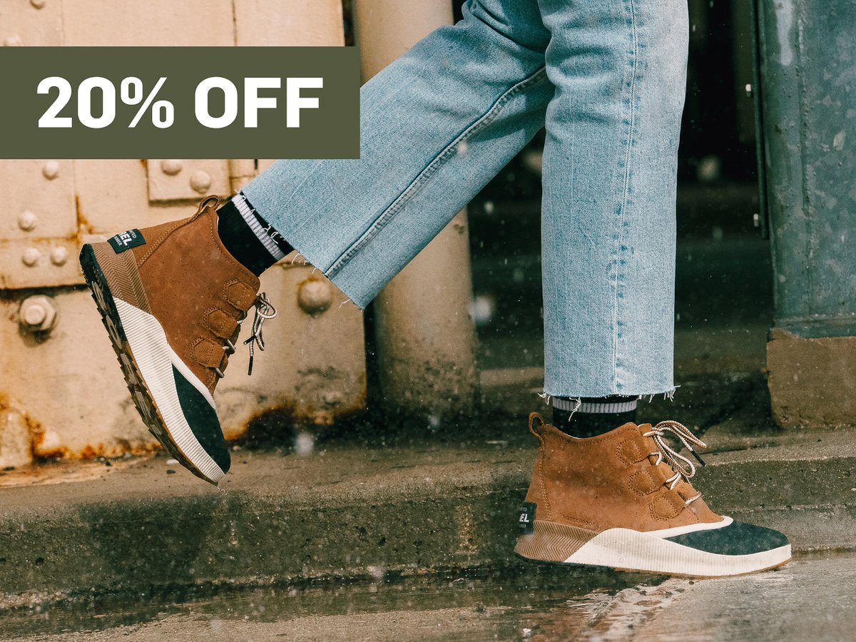 Someone walks on pavement in boots.  A promotional flag says 20% off in the top right corner.