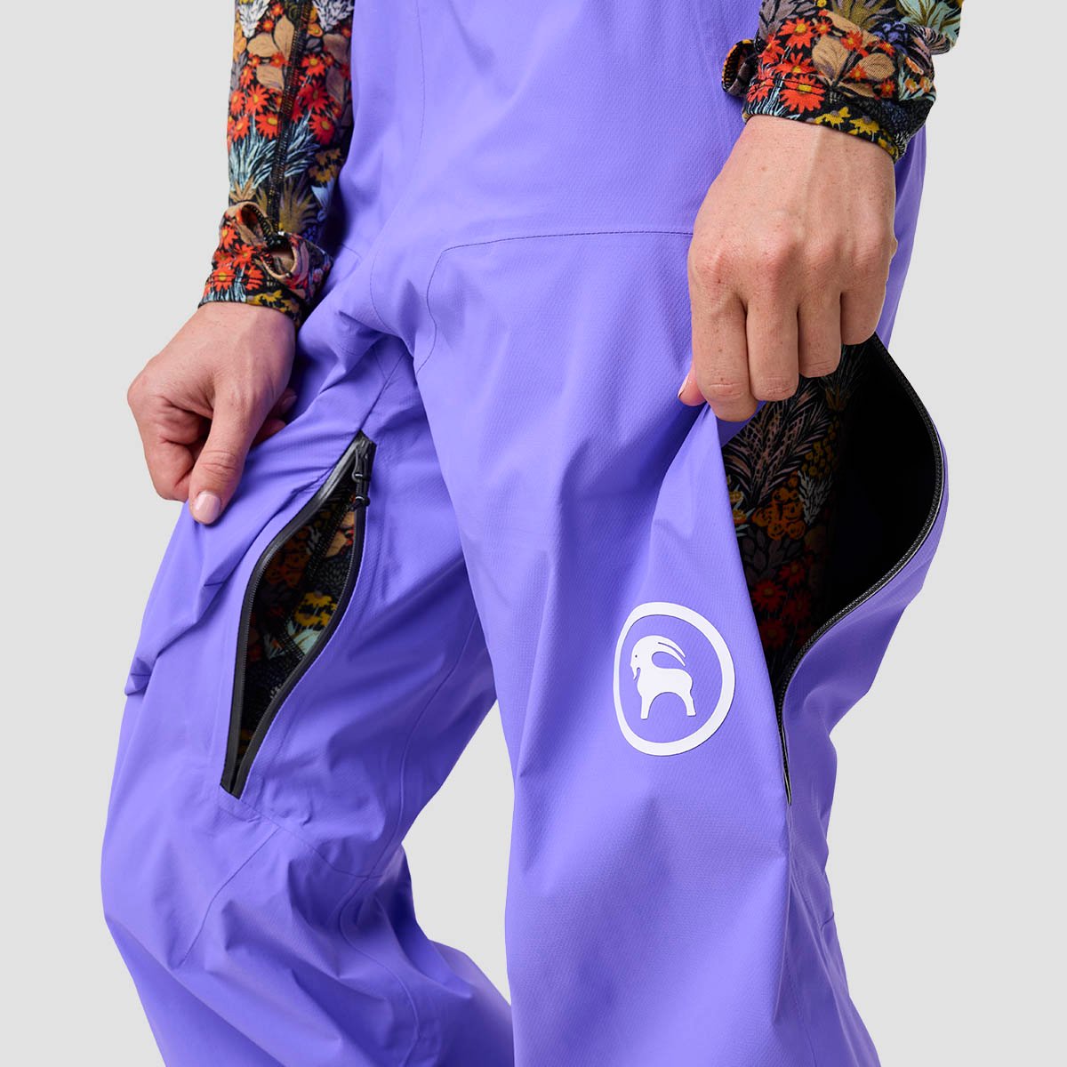 Person wearing Cottonwoods LT bibs standing at three-quarters angle showsn waist down with both inner and outer vents open.