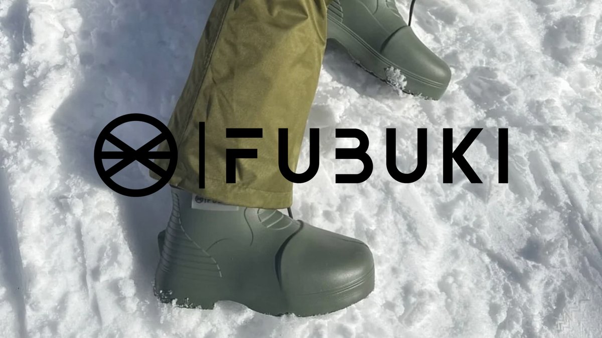 Person wearing sage green FUBUKI winter boots and matching snow pants while standing in deep snow.
