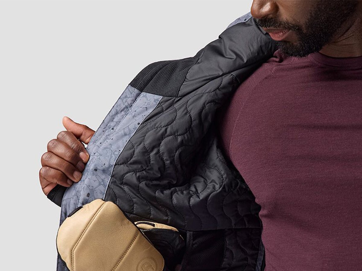 Model showing jacket interior with insulated baffle stitching.