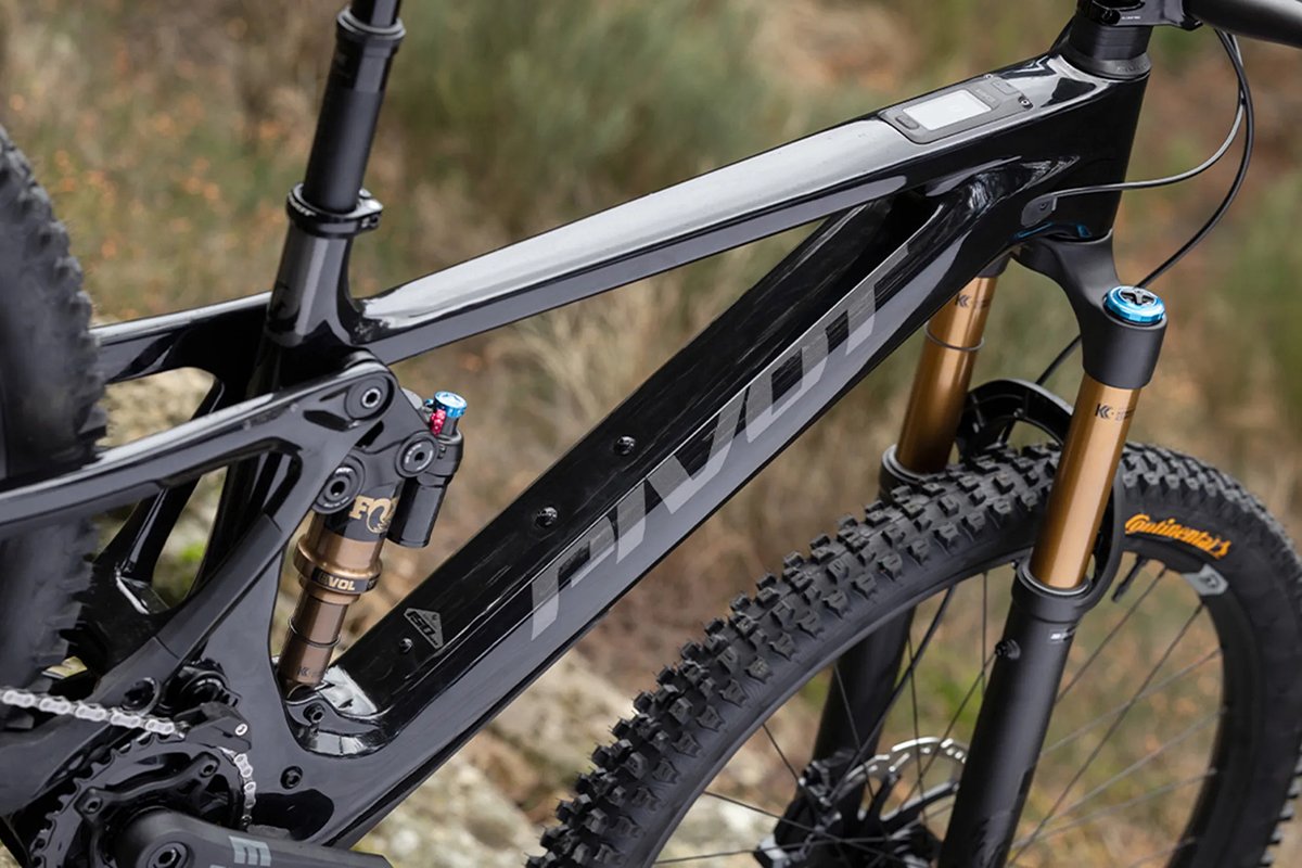 Pivot full-suspension mountain bike with Fox rear shock and gold fork staged on rocky dry terrain