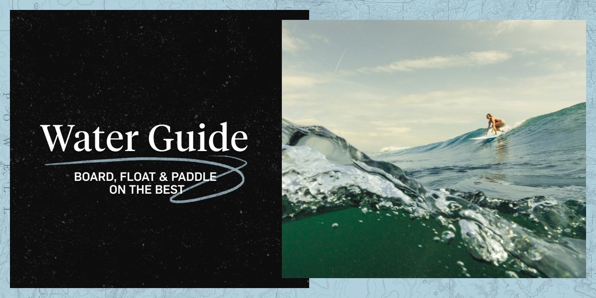 A surfer begins to stand on their board. The camera is slightly submerged in the water. The words read, “Water Guide, board, float & paddle on the best”. 