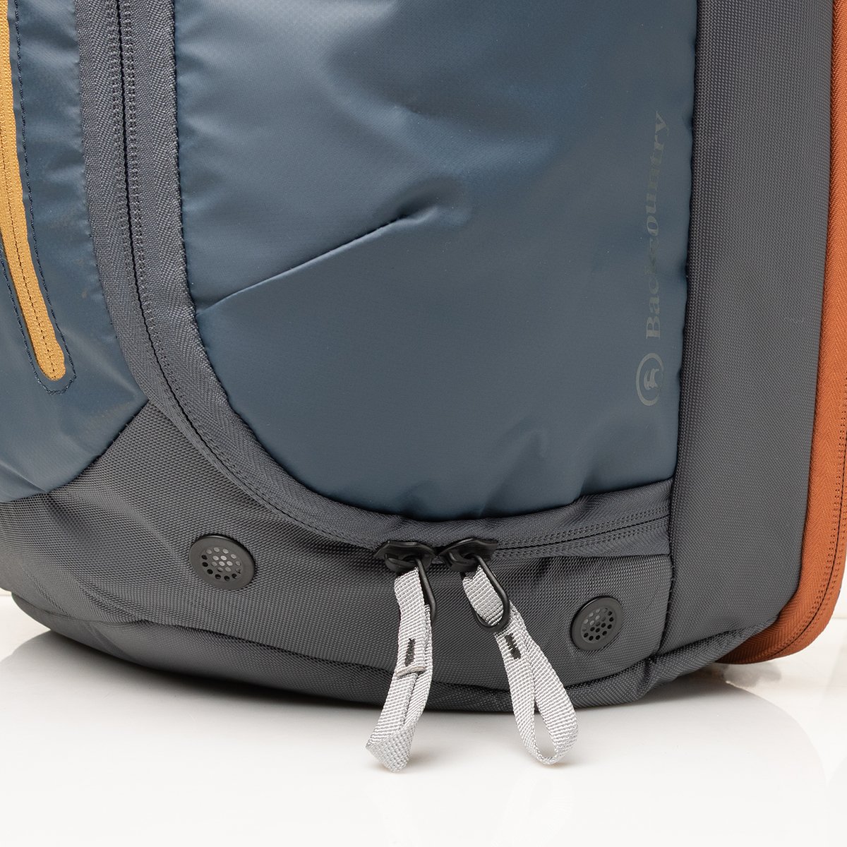 Close-up of a boot bag base with two ventilated eyelets.