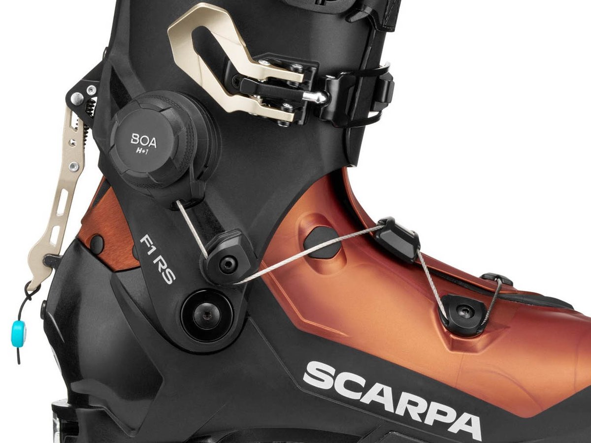 Close-up of SCARPA F1 RS BOA H+1 dial on copper and black shell showing FS Lever mechanism and F1 RS model labeling