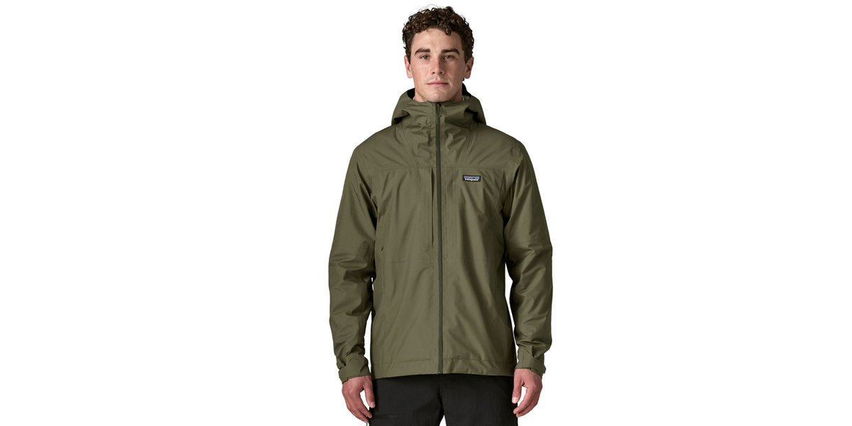 A man wears a green Boulder Fork Rain Jacket