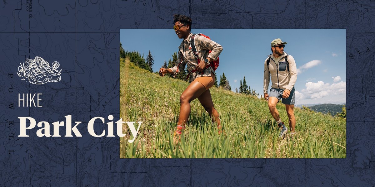 Two people hike through a grassy field. The words, “Hike Park City” appear next to them.