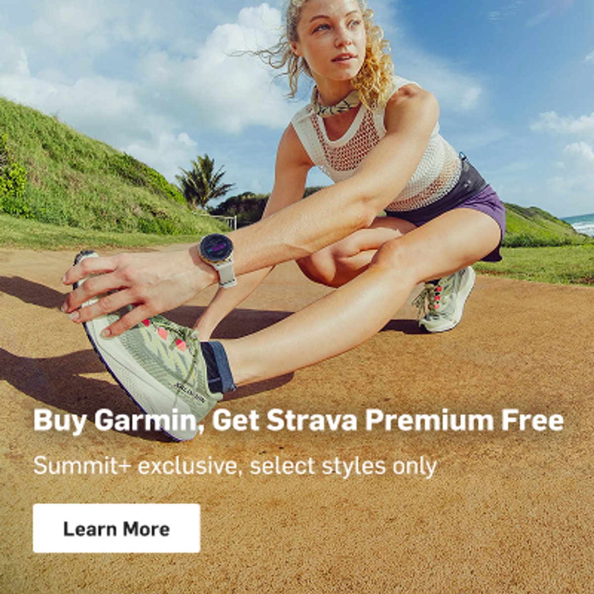 Runner stretching on a dirt path beside a grassy hillside, with a smartwatch on her wrist: “Buy Garmin, Get Strava Premium Free. Summit+ exclusive, select styles only. Learn More.”