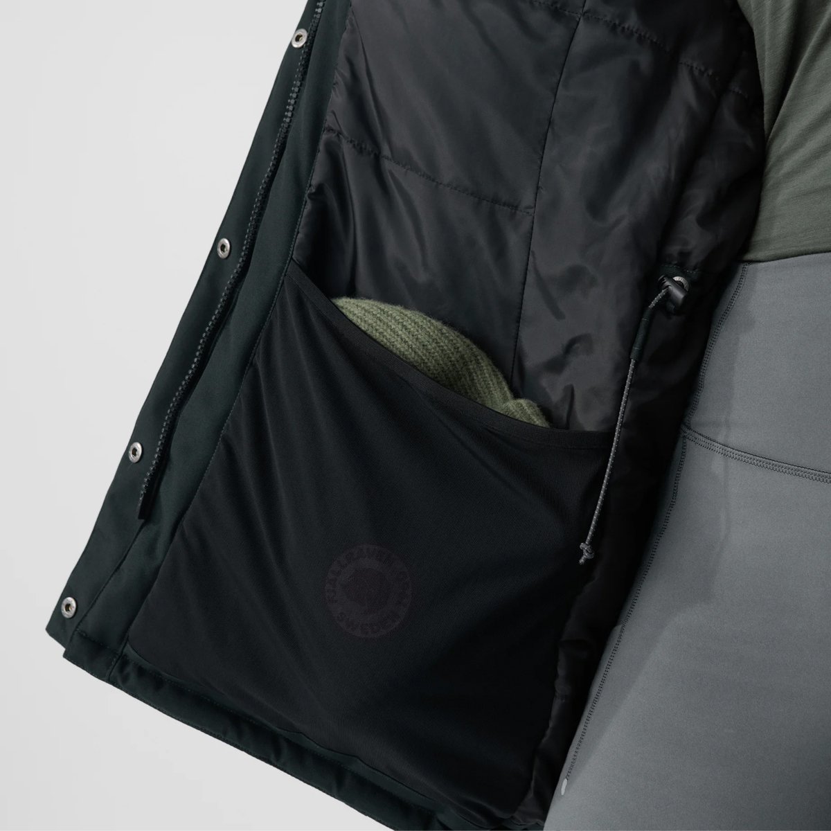 A closeup of the women's Fjallraven Nuuk parka interior pocket and drawstring.