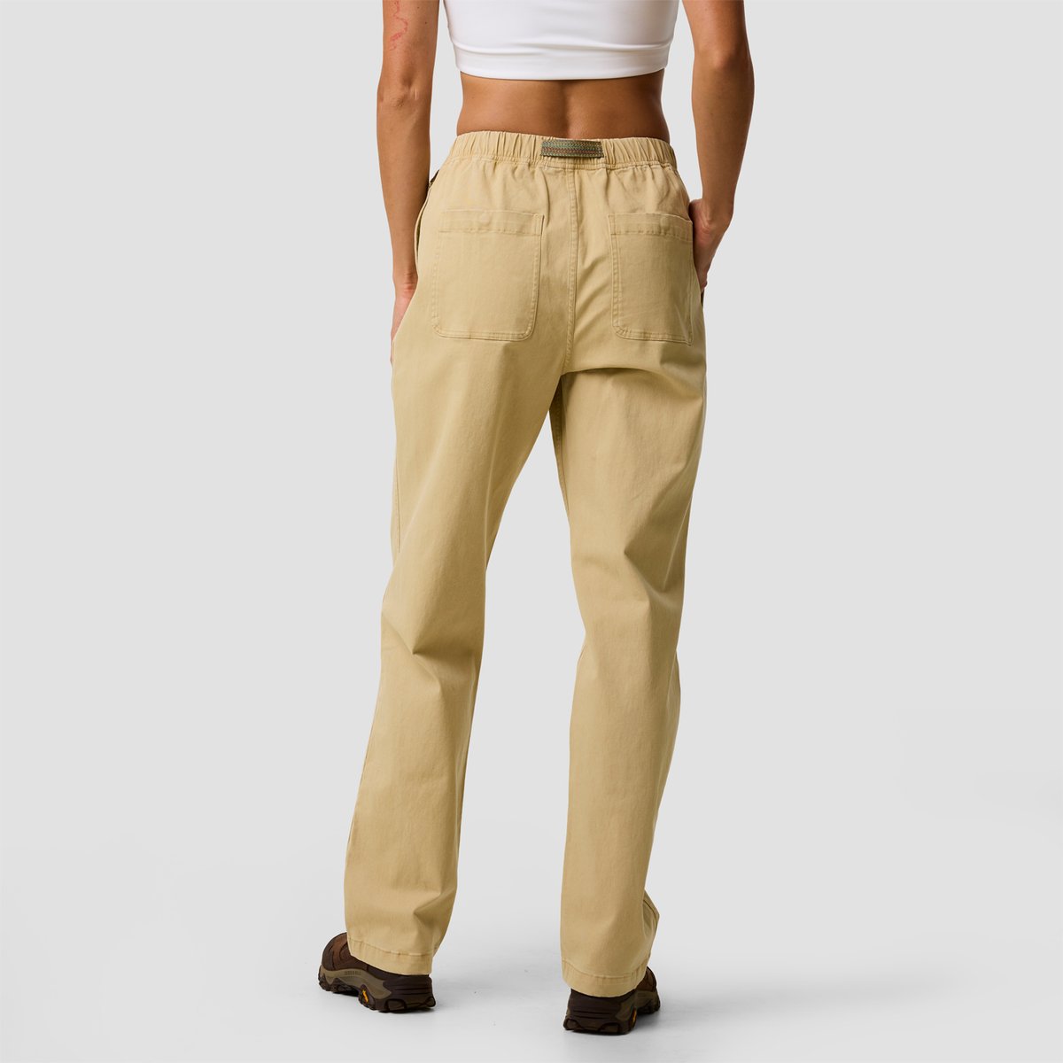 A woman wears the BGA Venture Daily relaxed-fit pants with elastic waistband and rear pockets, viewed from behind.