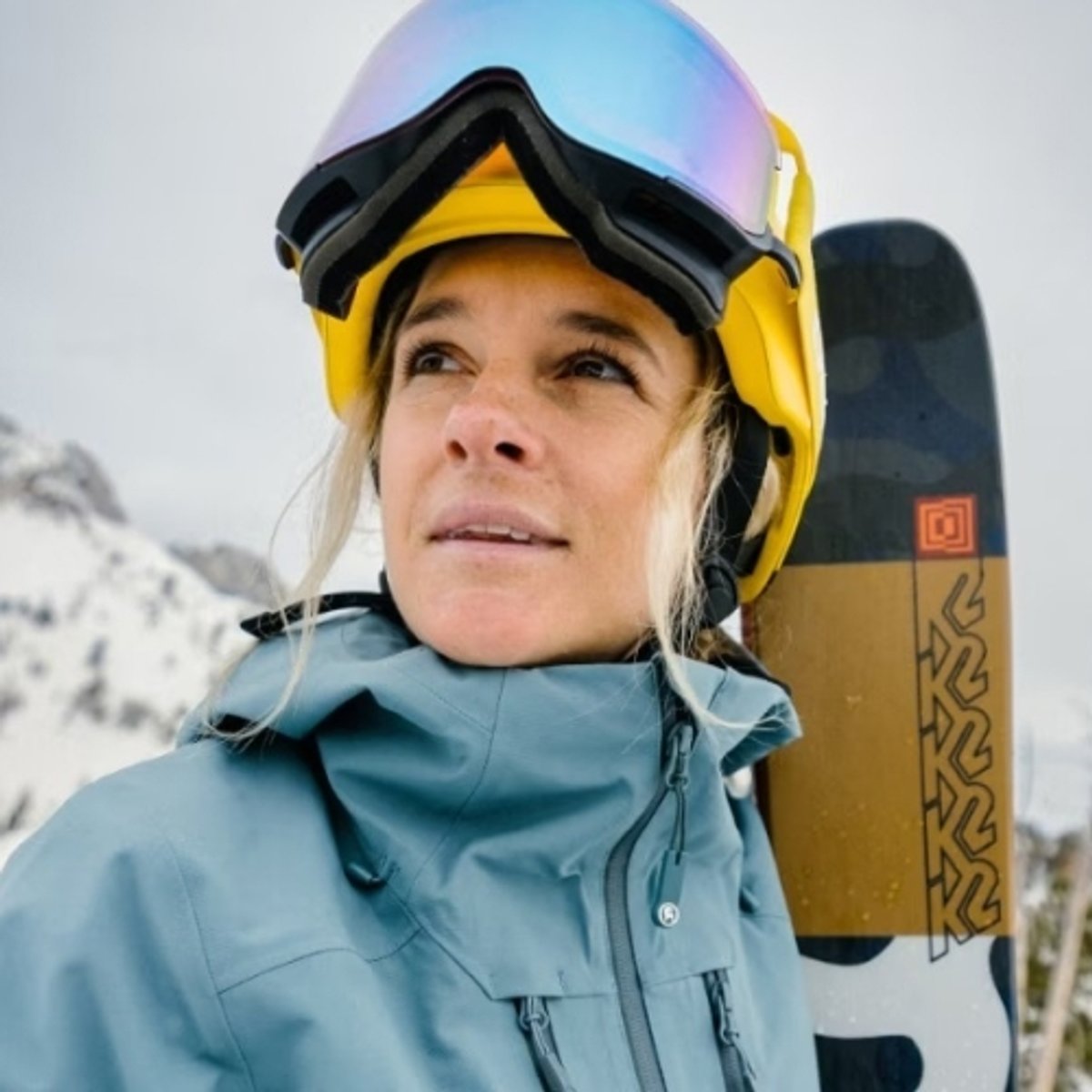 Lexi Dupont gazes across the mountain side while wearing her ski gear. 