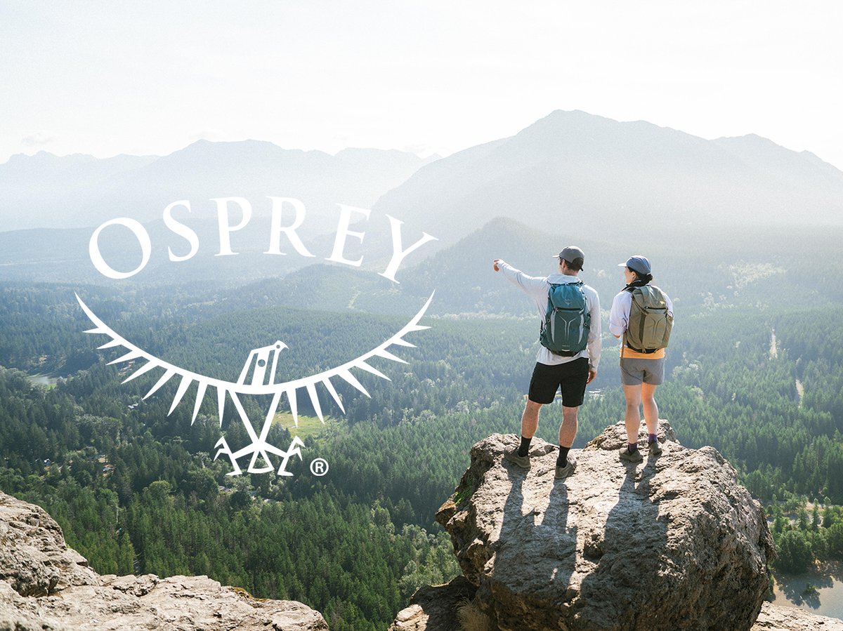 Two hikers wearing bacpacks looking out over mountain valley view with Osprey bird logo overlay.