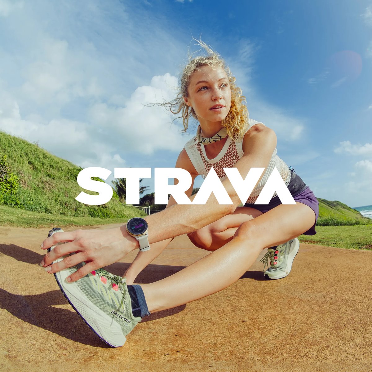 A runner stretches wearing a garmin watch. the logo over the image reads strava