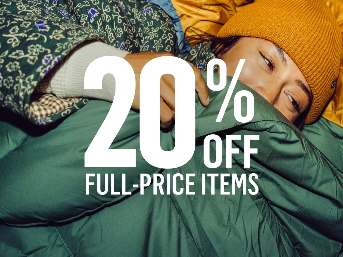 Person bundled in a sleeping bag wearing a beanie. 20% off full-price items.