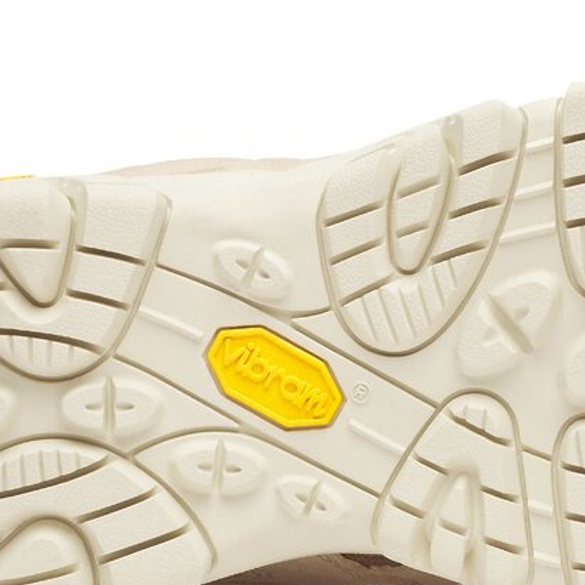 Bottom view of a hiking boot outsole showing multidirectional lug pattern and Vibram branding badge.