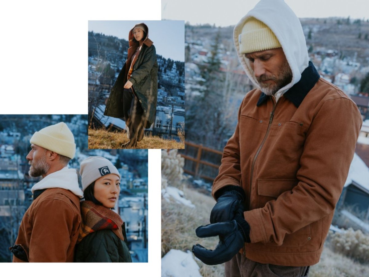 A man wearing a waxed canvas jacket and a woman wearing a longline quilted coat.