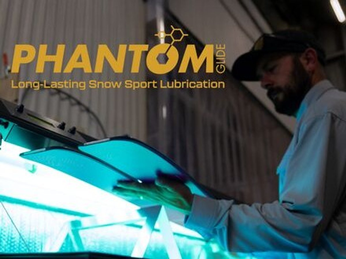 Backcountry technician curing skis under the Phantom Glide UV station